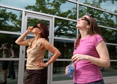 Christine Guzy and Maria Weber view eclipse through glasses