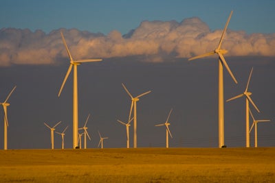 Clouds behind a turbine-studded wheat field