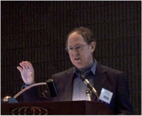 Schneider at lecturn in 2010