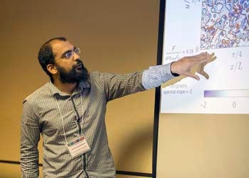 Postdoc Navid Constantanou showing his research