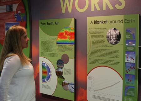 Becca Hatheway in front of the climate exhibit